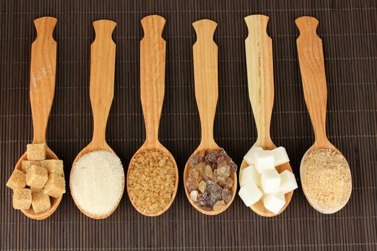 Różne rodzaje cukru w łyżkach na stole